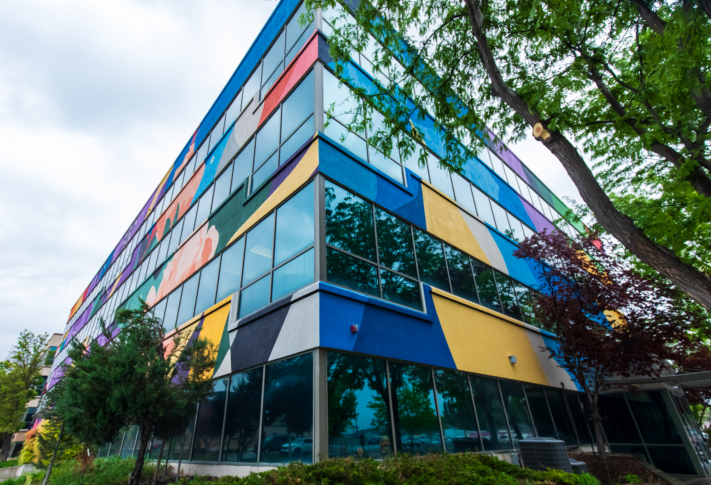 "Flourish," a mural by the artist DAAS, is pictured on the north and west sides of South Salt Lake City Hall on Monday.