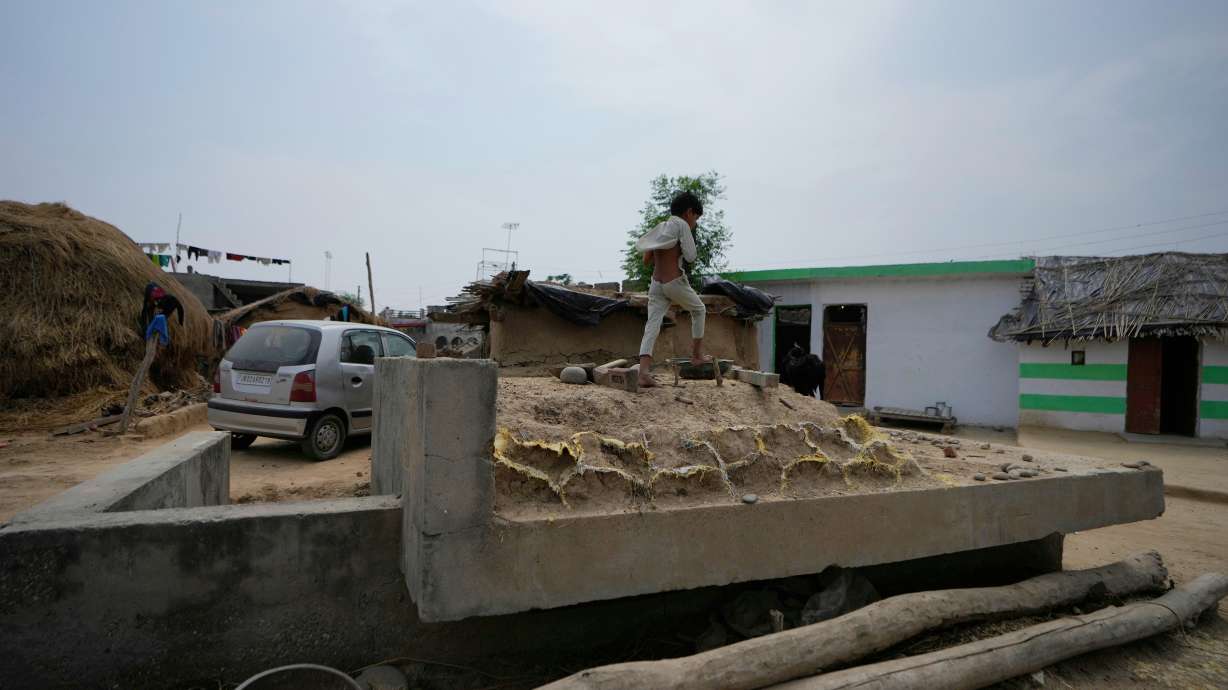 Indian child walk on bunker near India-Pakistan International border at in Jora farm village, in Ranbir Singh Pura about 22 miles from Jammu, India, Tuesday. India has fired missiles at Pakistan, killing 26.
