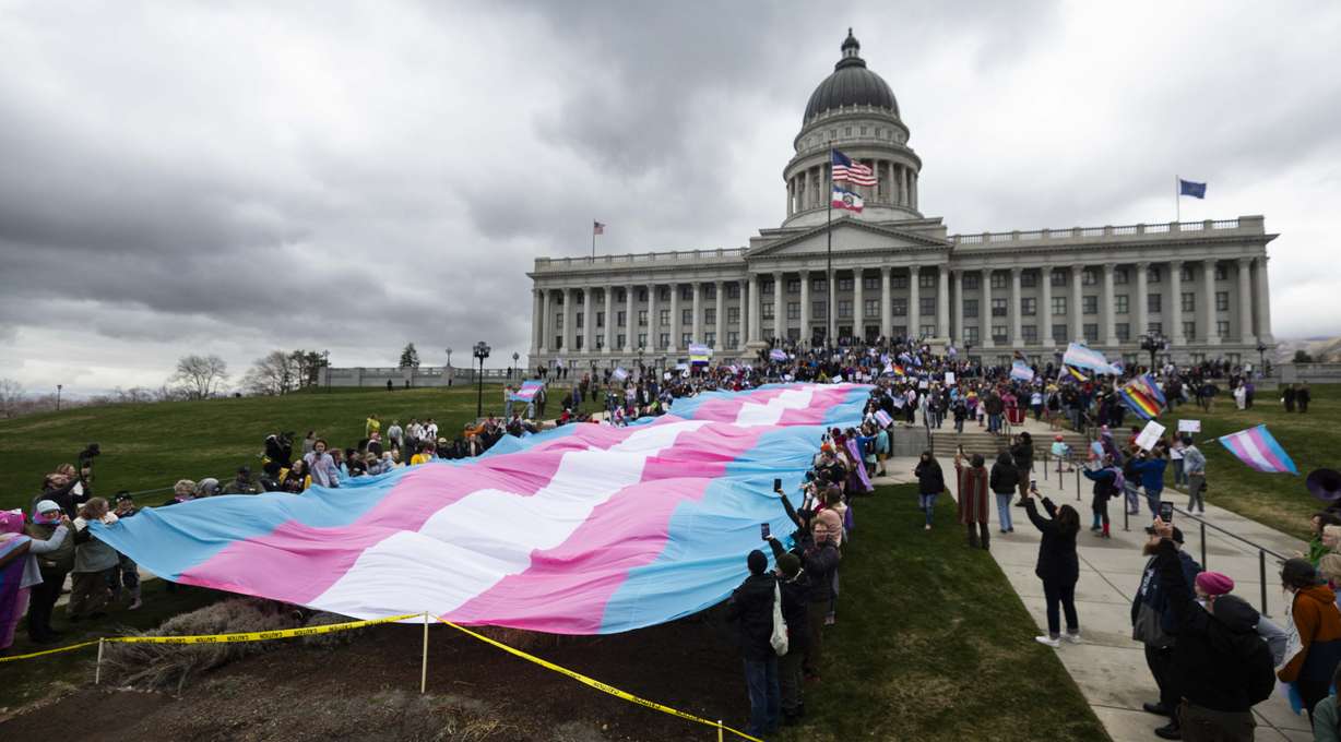 Protesters unfurl a 200-foot transgender flag during the start of a march down State Street starting at the Capitol for Transgender Day of Visibility in Salt Lake City on March 29.