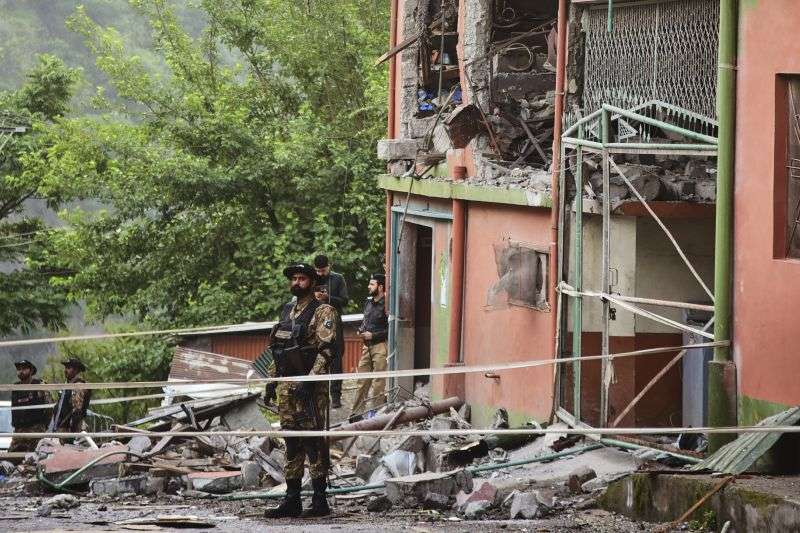 Army soldiers stand guard at a mosque building damaged by a suspected Indian missile attack near Muzaffarabad, the capital of Pakistan controlled Kashmir, on Wednesday.