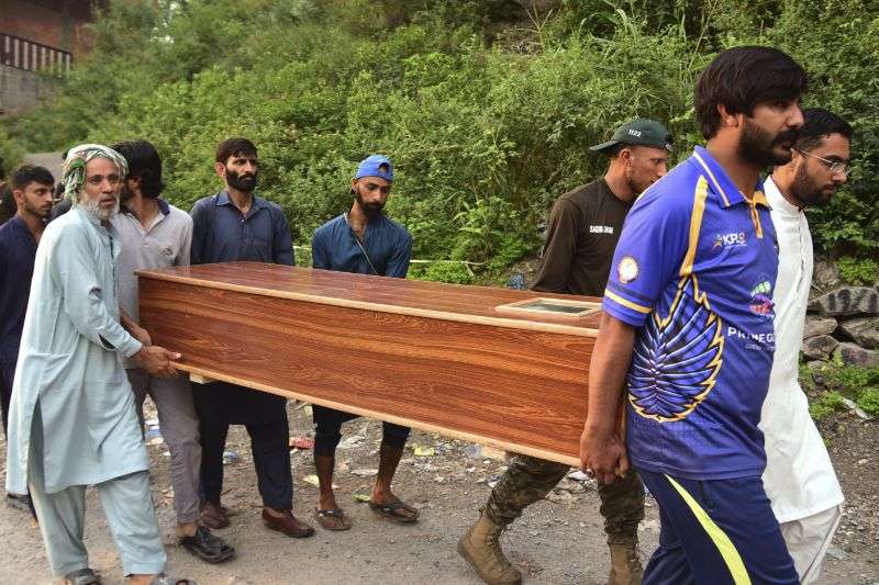 Volunteers carry a body after recovering it from the rubble of a mosque building damaged by a suspected Indian missile attack near Muzaffarabad, the capital of Pakistan controlled Kashmir, on Wednesday.