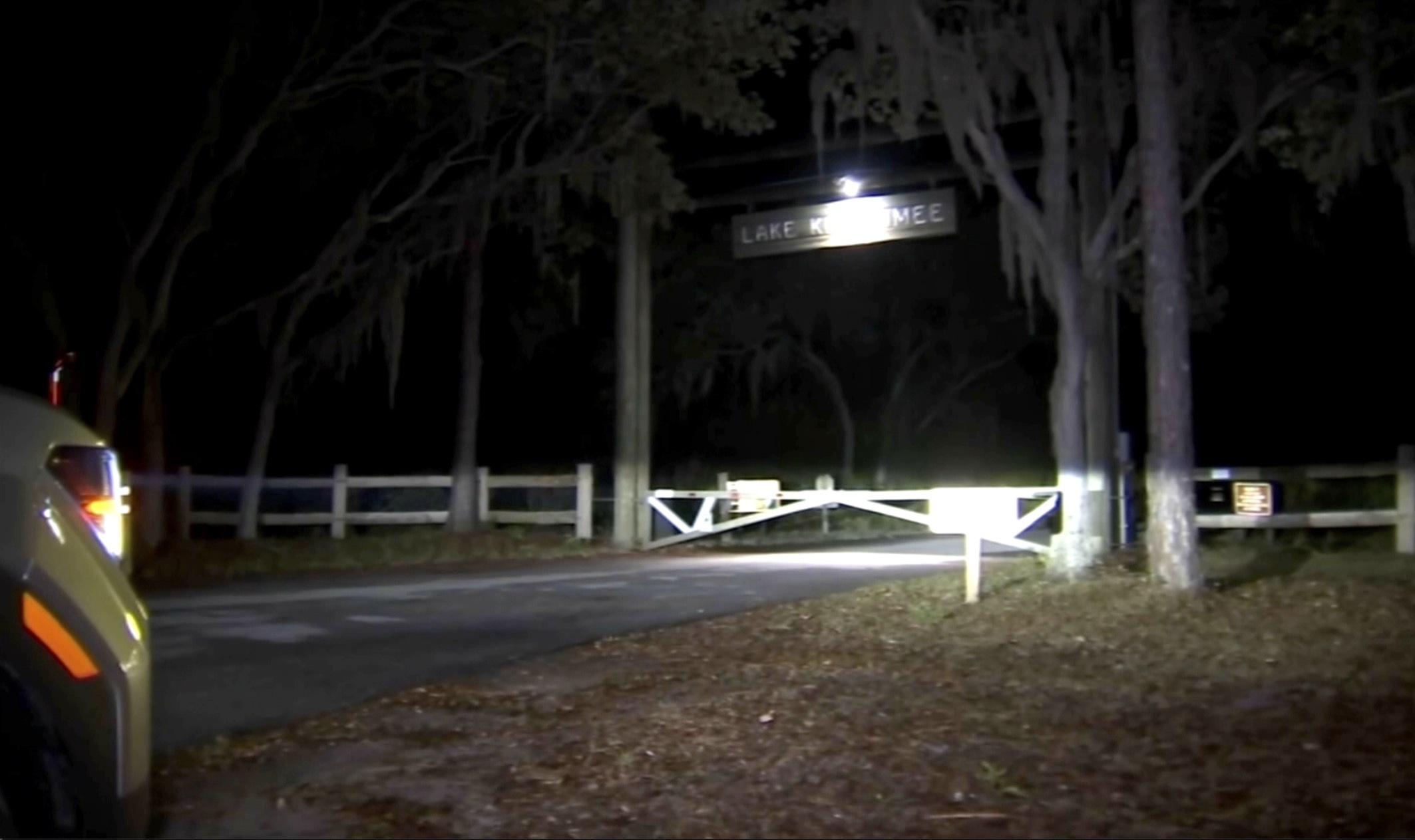 A vehicle is parked outside the gates of the Lake Kissimmee in Polk County, Fla., on Tuesday. An alligator killed a Florida woman after tipping over a canoe, which investigators say appeared to be an accidental encounter.