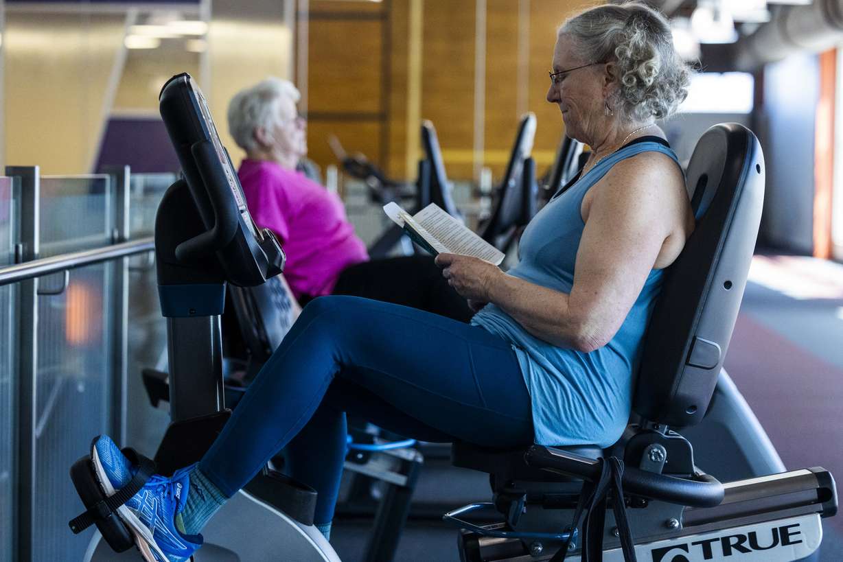 Susanne Garrett reads while exercising at the Millcreek Community Center in Millcreek on Wednesday. Salt Lake County is the first community in Utah to be designated an AARP Age-Friendly Community.