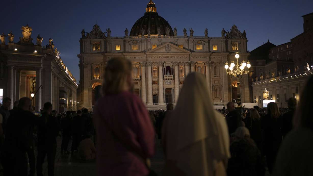 People gather in St Peter's Square as they wait to see the smoke billow from the chimney of the Sistine Chapel in St Peter's Square during the cardinals' conclave to elect a new pope, at the Vatican, Wednesday.