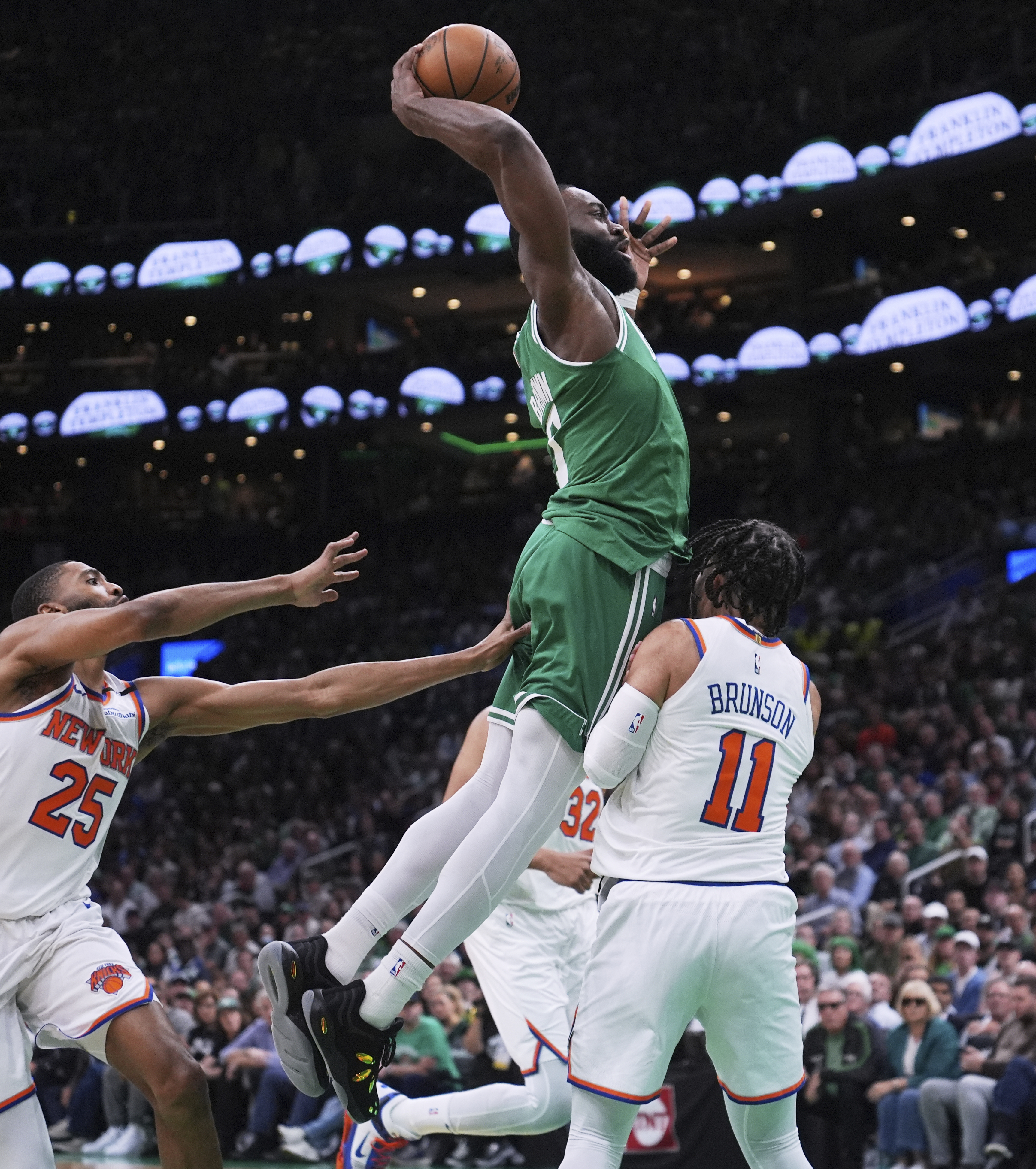Boston Celtics guard Jaylen Brown, center, drives to the basket against New York Knicks guard Jalen Brunson (11) during the first half of Game 2 of an NBA basketball second-round playoff series, Wednesday, May 7, 2025, in Boston.