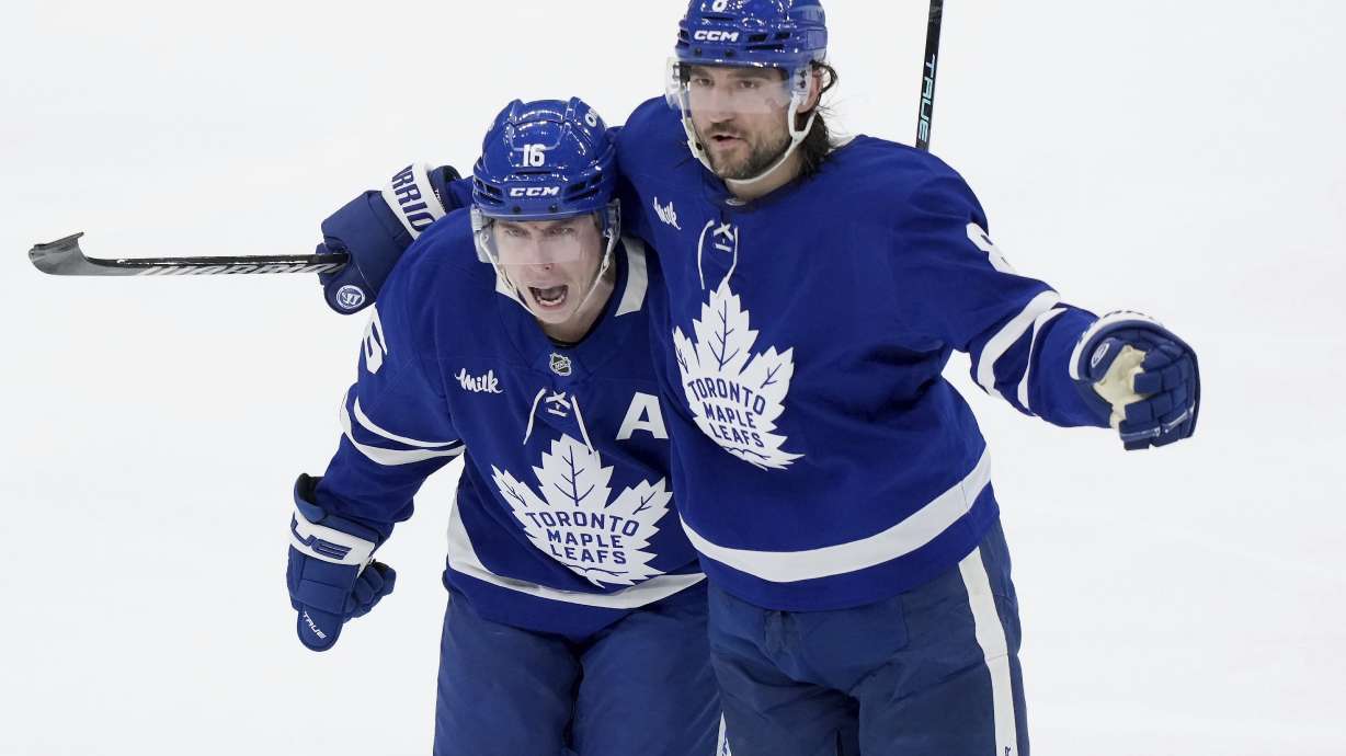 Toronto Maple Leafs' Mitch Marner (16) celebrates his goal with Chris Tanev (8) during the third period of an NHL hockey playoff game against the Florida Panthers in Toronto on Wednesday, May 7, 2025.