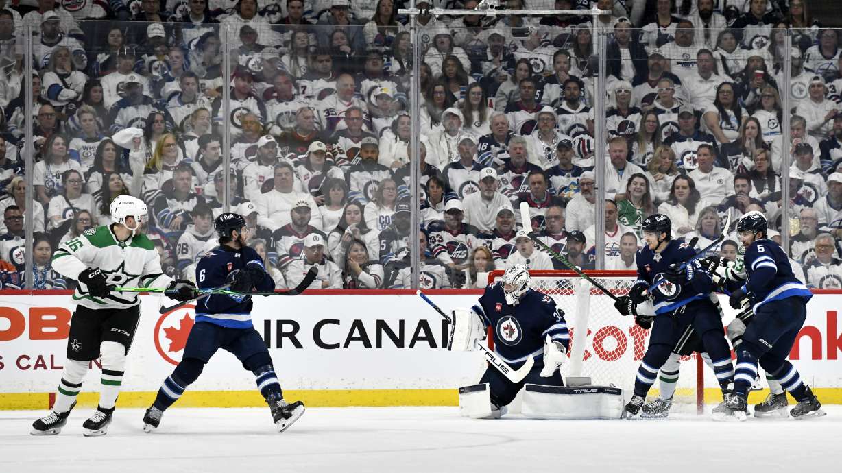 Dallas Stars' Mikko Rantanen (96) scores on Winnipeg Jets goaltender Connor Hellebuyck (37) during second period NHL playoff hockey action in Winnipeg, Wednesday, May 7, 2025.