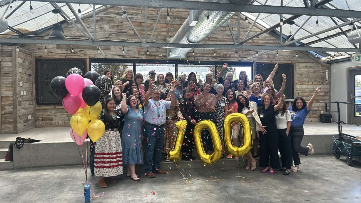 The members of the organization celebrate reaching the 100 women milestone.