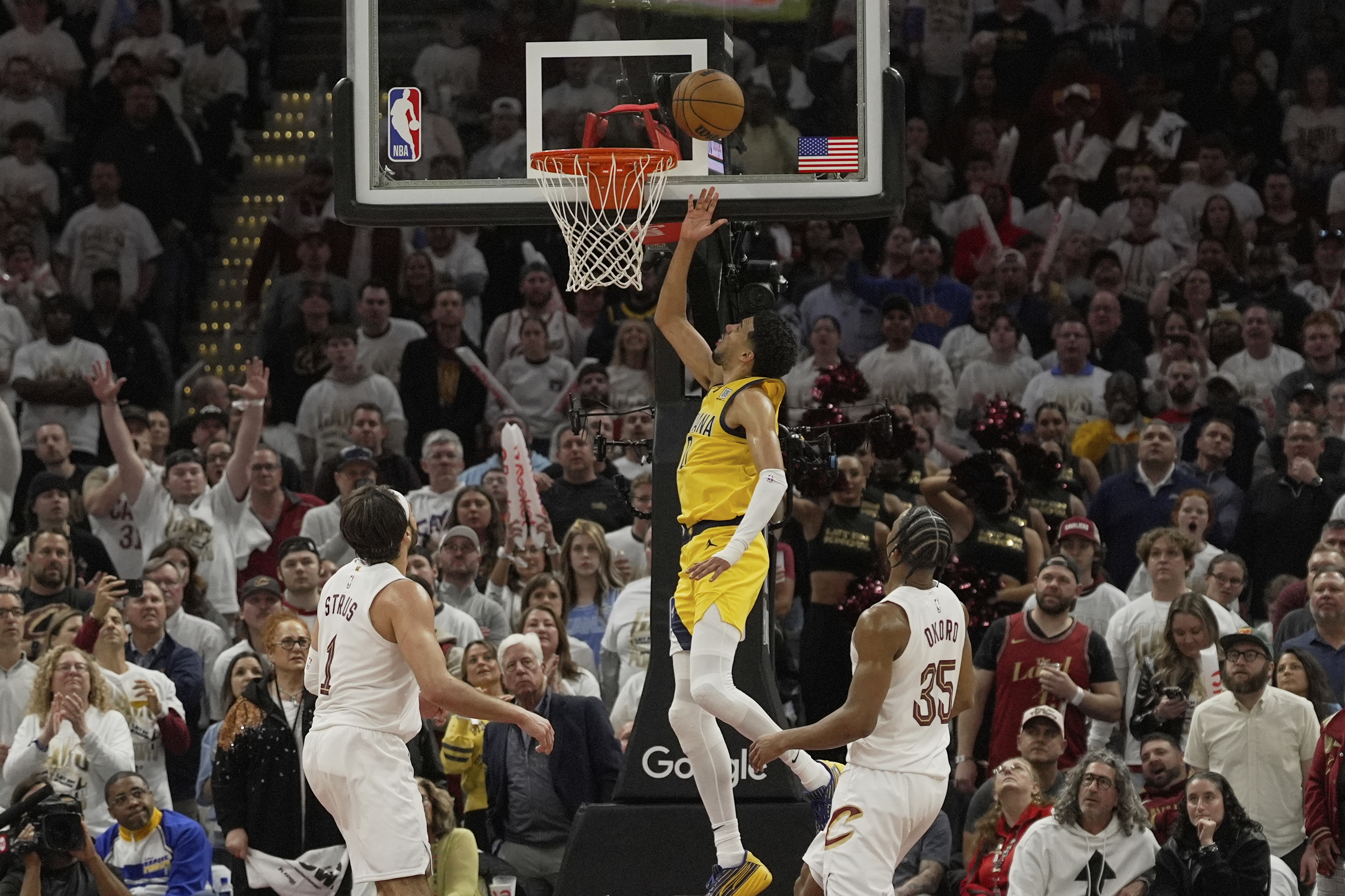 Indiana Pacers guard Tyrese Haliburton, center, shoots between Cleveland Cavaliers guard Max Strus (1) and forward Isaac Okoro (35) in the second half during Game 2 in the Eastern Conference semifinals of the NBA basketball playoffs Tuesday, May 6, 2025, in Cleveland.