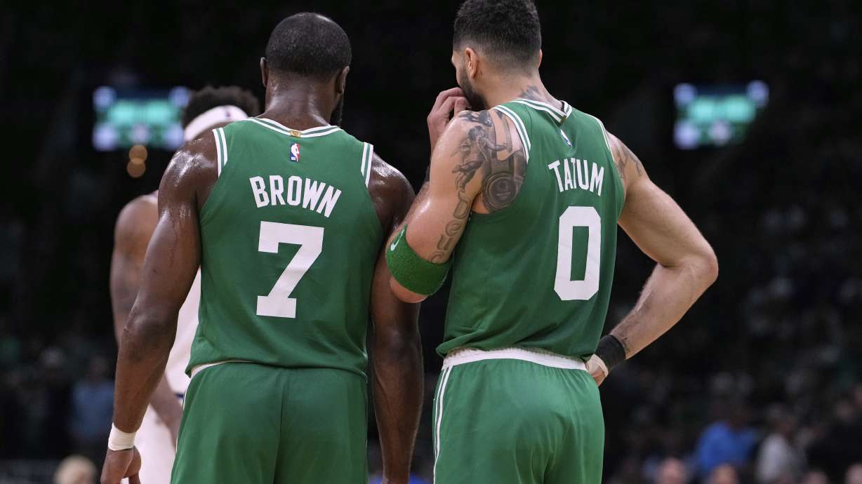 Boston Celtics forward Jayson Tatum (0) and guard Jaylen Brown (7) talk during the second half of Game 2 of an NBA basketball second-round playoff series against the New York Knicks, Wednesday, May 7, 2025, in Boston.