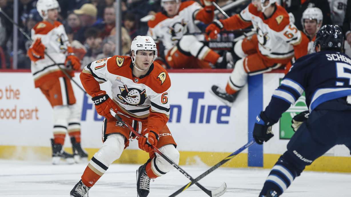 Winnipeg Jets' Mark Scheifele (55) defends against Anaheim Ducks' Cutter Gauthier (61) during first period NHL action in Winnipeg on Wednesday, April 16, 2025.
