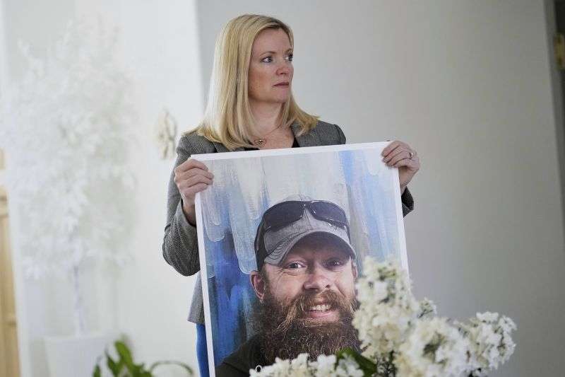 Stacey Wales, sister of the late Christopher Pelkey, displays her brother's image at her mother's home, Wednesday, in Chandler, Ariz.