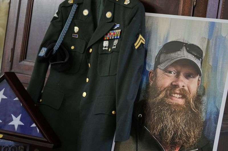 The Army dress uniform and photo of the late Christopher Pelkey is shown at his mother's home, Wednesday, in Chandler, Ariz.