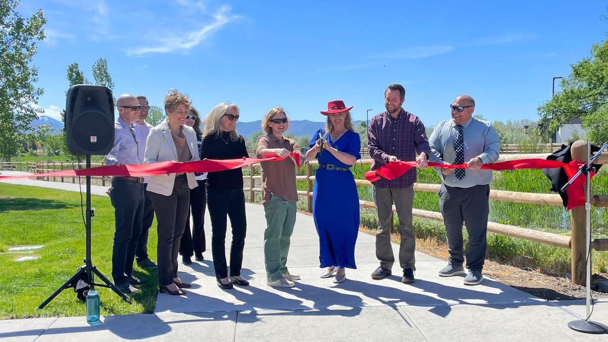 Sandy Mayor Monica Zoltanski cuts the ribbon to the city's new wetlands park on Thursday.