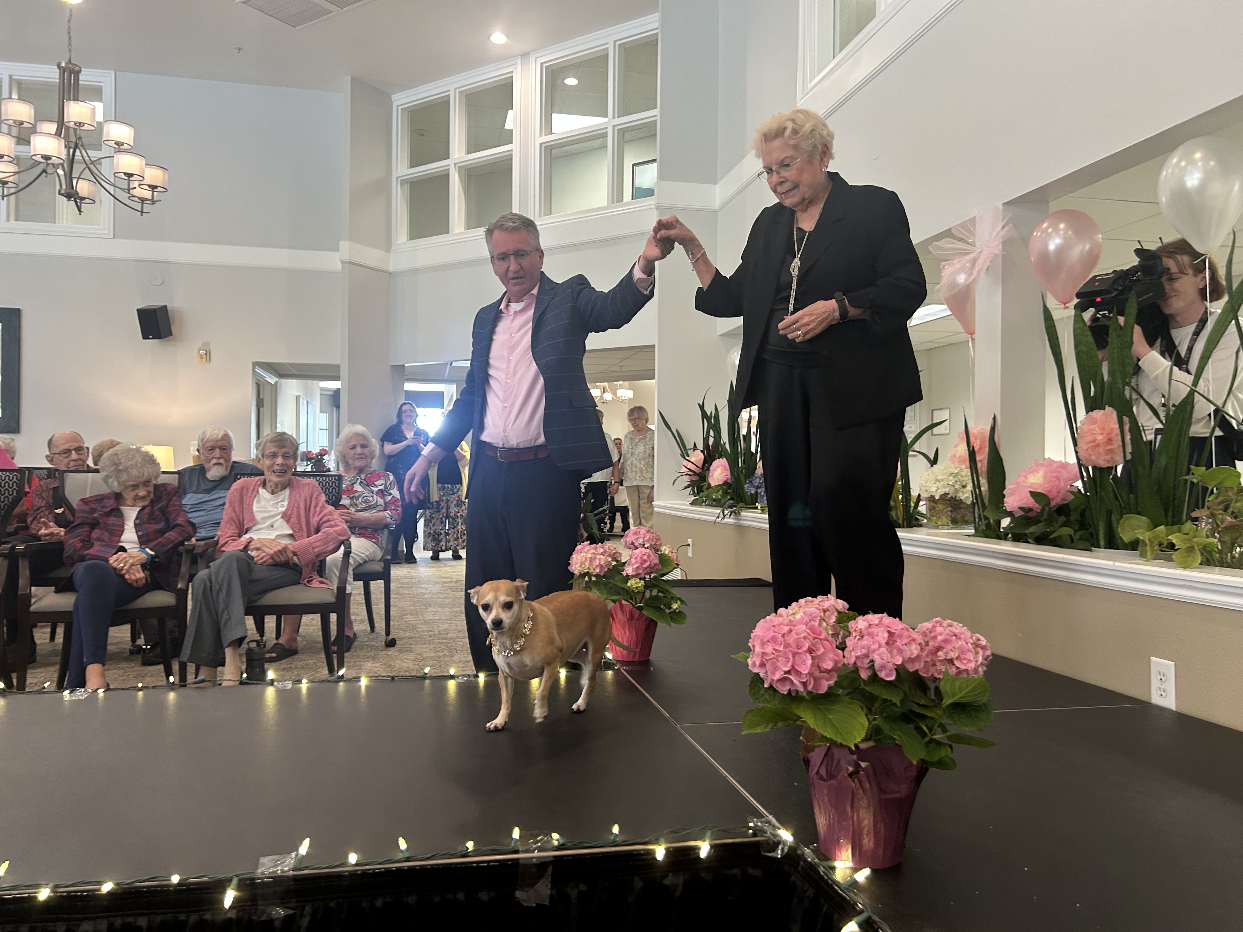 Reen Cathcart and her dog Zoey strut down the runway during a Mother's Day fashion show at Legacy Retirement in South Jordan on Thursday afternoon.