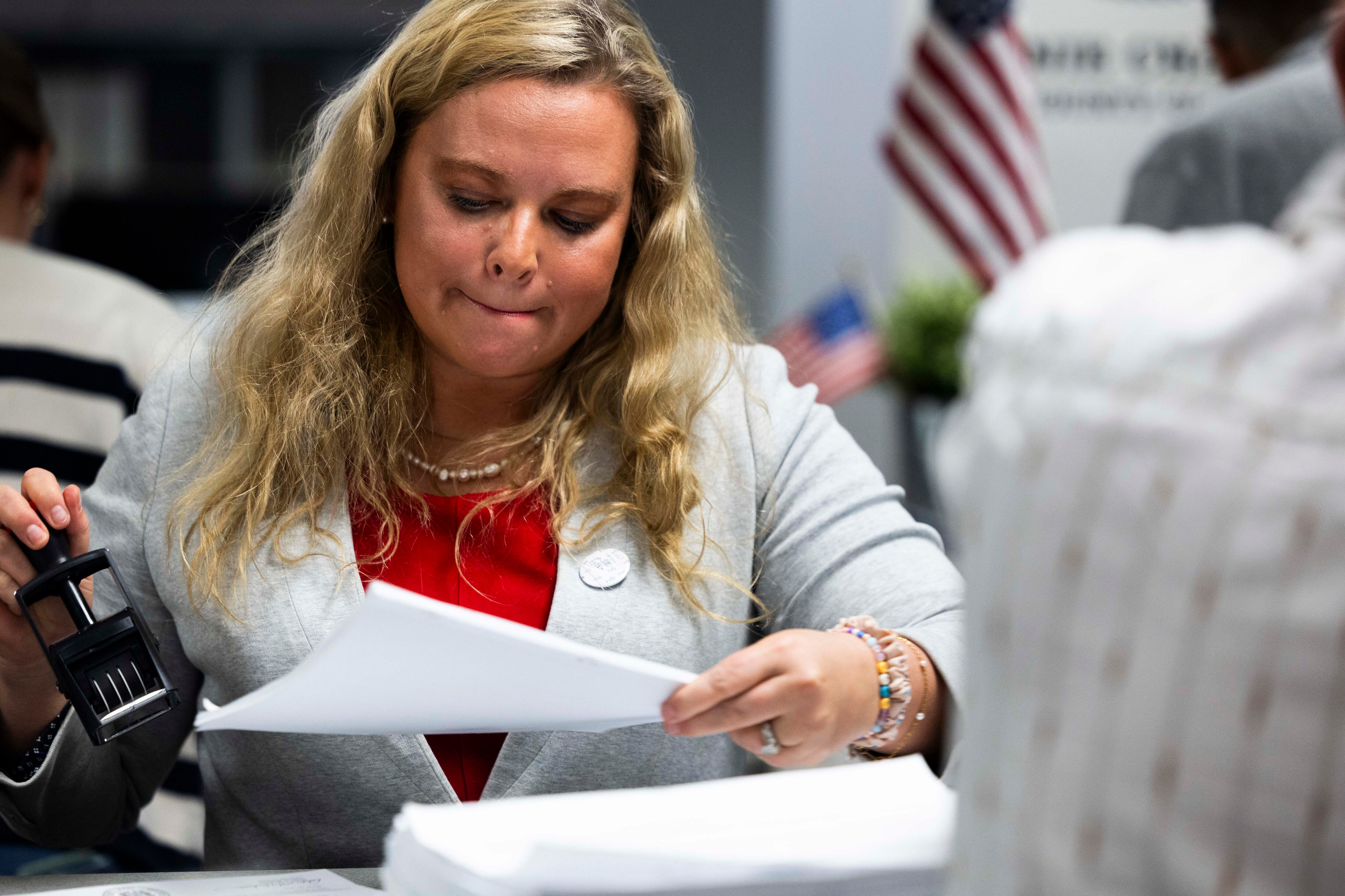Salt Lake County Clerk Lannie K. Chapman stamps and accepts signatures supporting a referendum on HB267 on April 16. The verification process is now complete, officials say.