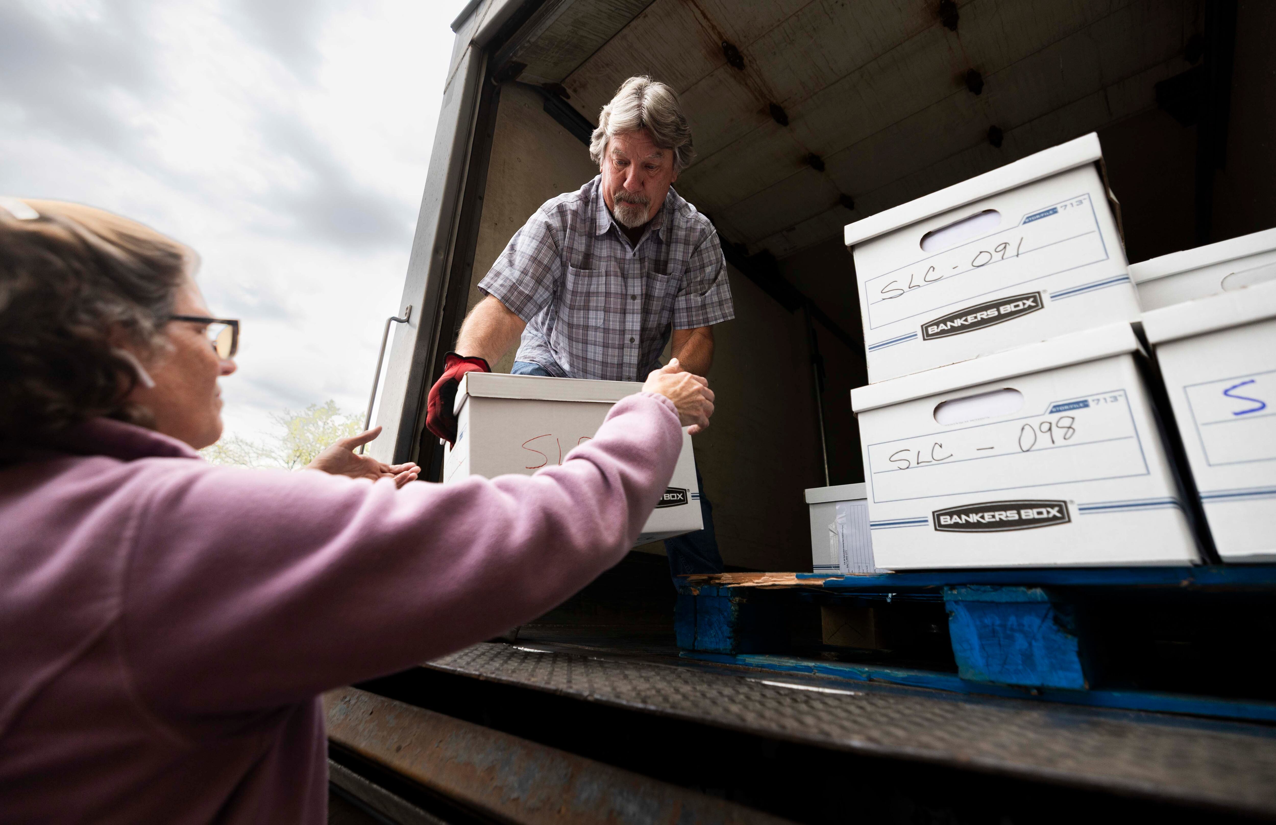 Larry Littlefield passes down boxes full of signatures bound for submission to the Salt Lake County Clerk's Office supporting a referendum on HB267 at the Salt Lake County Government Center in Salt Lake City on Wednesday.