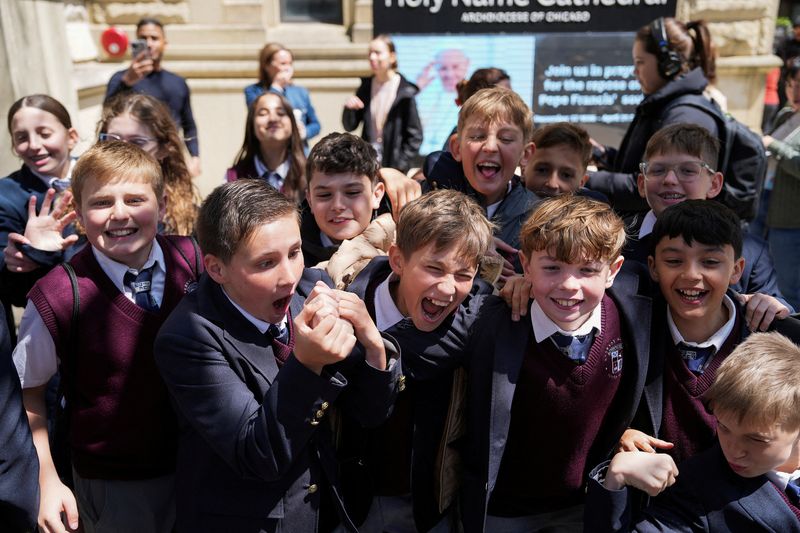 Students from Everest Academy in Lemont, IL, react after Cardinal Robert Prevost of the United States was announced as Pope Leo XIV, by the Holy Name Cathedral in Chicago, Illinois, Thursday.