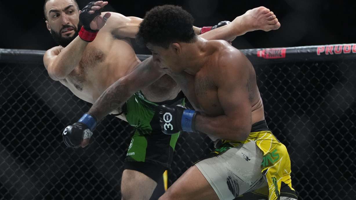 FILE - Belal Muhammad, left, kicks Brazil's Gilbert Burns during the first round of a welterweight bout at the UFC 288 mixed martial arts event, May 6, 2023, in Newark, N.J.