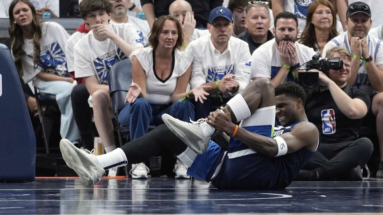 Minnesota Timberwolves guard Anthony Edwards (5) grabs his leg during the first half of Game 2 of an NBA basketball second-round playoff series against the Golden State Warriors, Thursday, May 8, 2025, in Minneapolis.