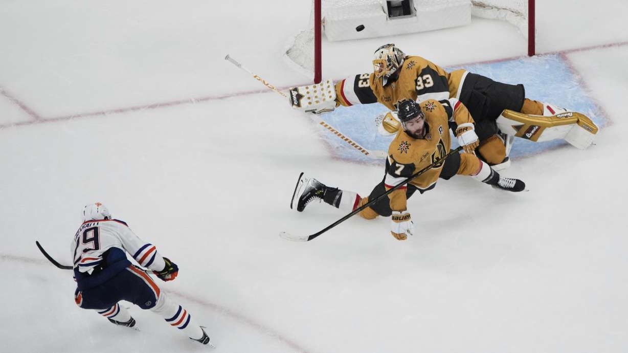 Edmonton Oilers center Leon Draisaitl (29) scores against Vegas Golden Knights goaltender Adin Hill (33) during overtime of Game 2 of a second-round NHL hockey playoff series Thursday, May 8, 2025, in Las Vegas.