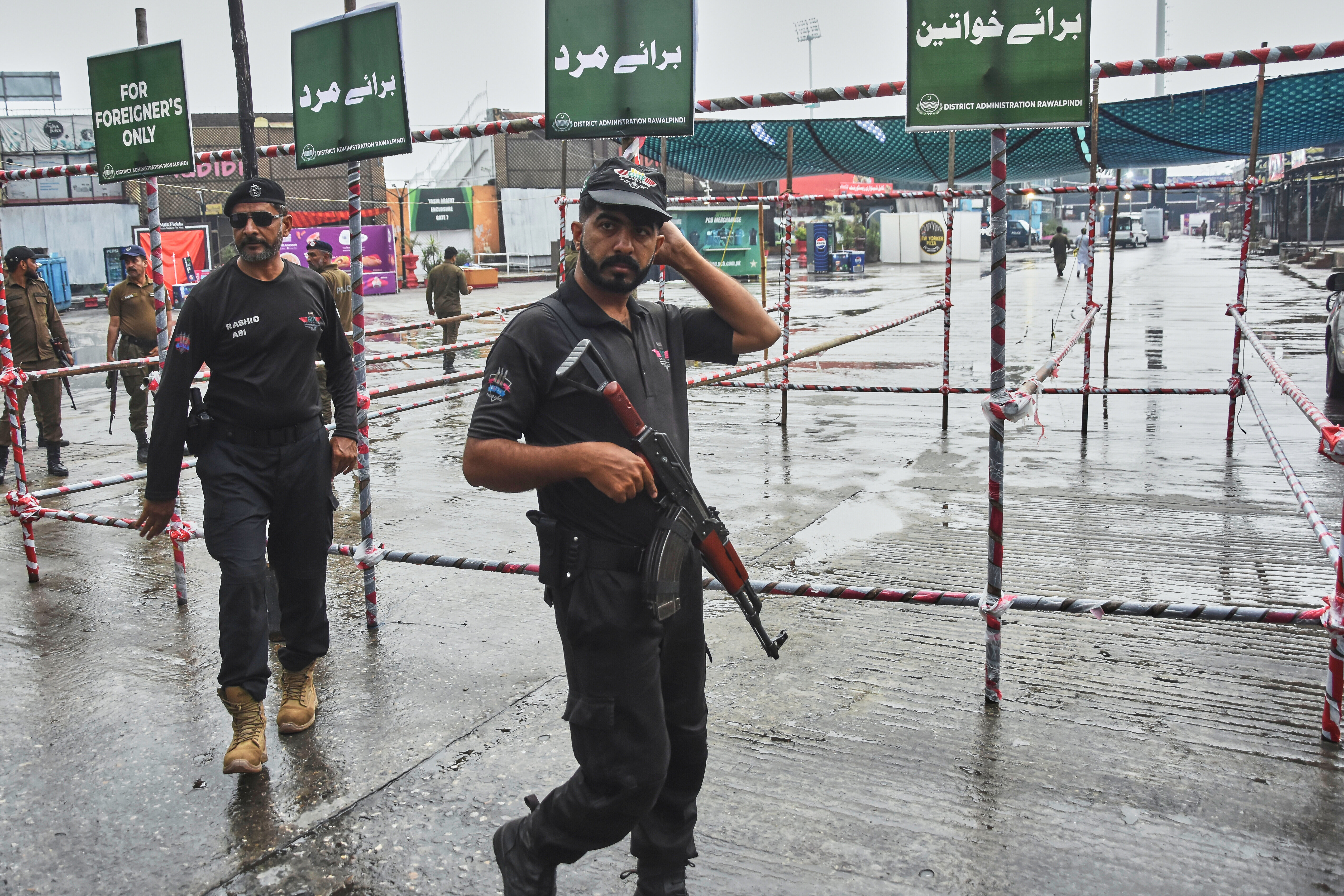 Police officers stand guard at an entry point to Pindi Cricket Stadium following the crash of a suspected Indian drone in the parking area, in Rawalpindi, Pakistan, Thursday, May 8, 2025. 