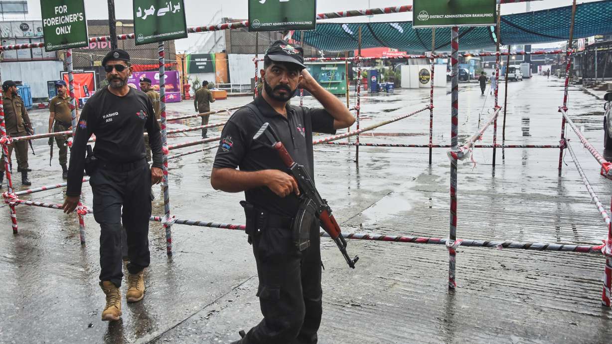 Police officers stand guard at an entry point to Pindi Cricket Stadium following the crash of a suspected Indian drone in the parking area, in Rawalpindi, Pakistan, Thursday, May 8, 2025.