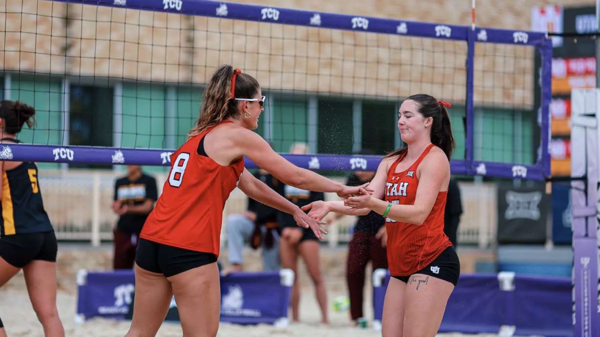 Utah beach volleyball players celebrate a point won against No. 10 Arizona State on April 25, 2025, in Fort Worth, Texas.