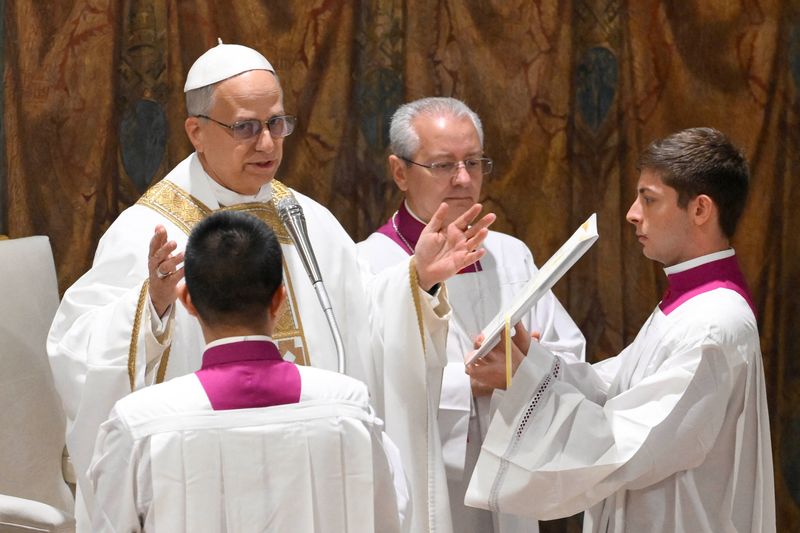 Pope Leo XIV conducts Mass in the Sistine Chapel at the Vatican, Friday.