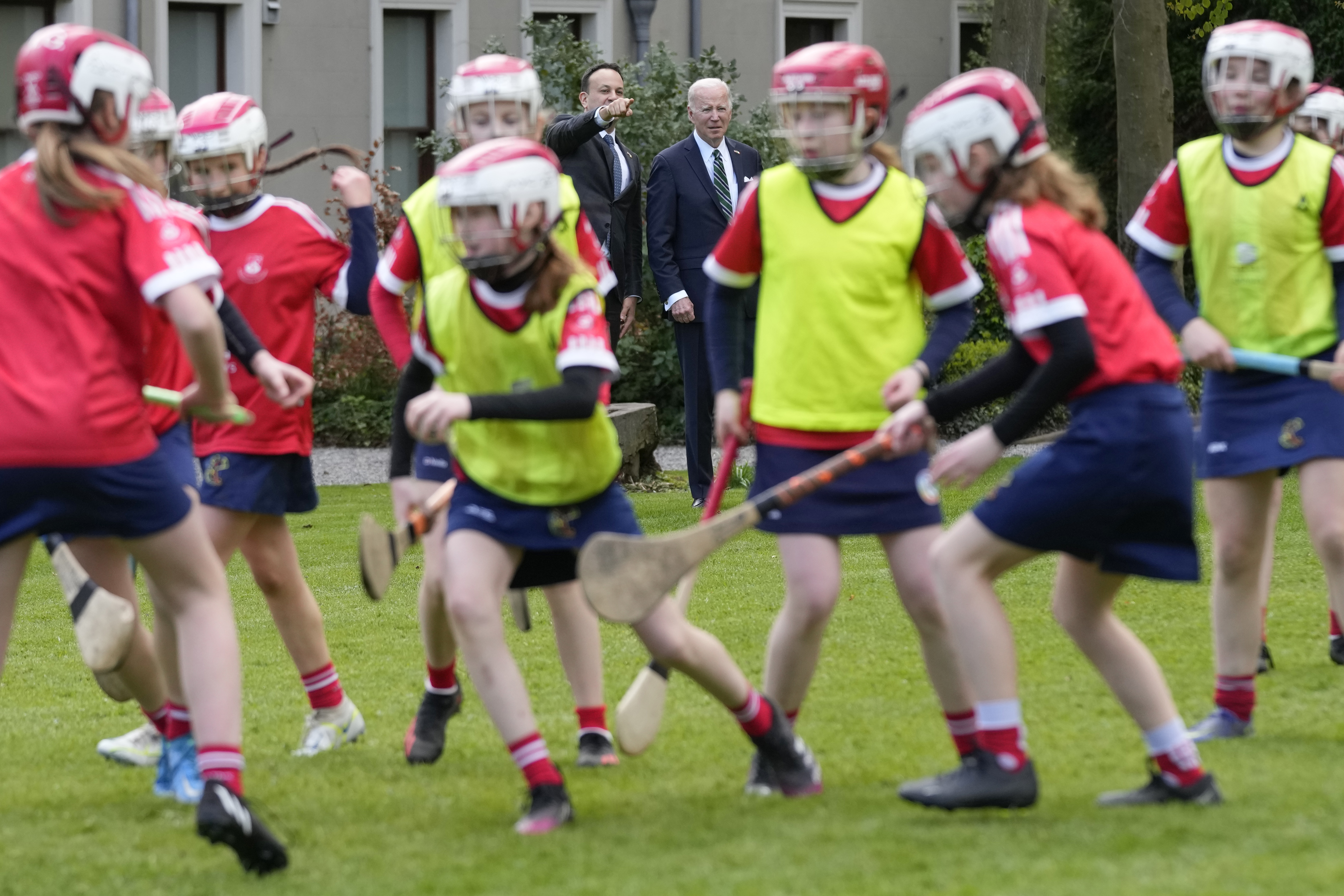 FILE - President Joe Biden and Ireland's Taoiseach Leo Varadkar watch as girls play hurling during a youth Gaelic sports demonstration at Farmleigh House, Thursday, April 13, 2023, in Dublin, Ireland.