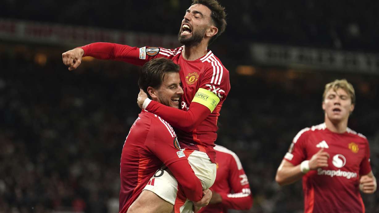 Manchester United's Mason Mount, left, celebrates with Bruno Fernandes after scoring their first goal of the game during the Europa League semifinal second leg soccer match between Manchester United and Athletic Bilbao in Manchester, Britain, Thursday, May 8, 2025.