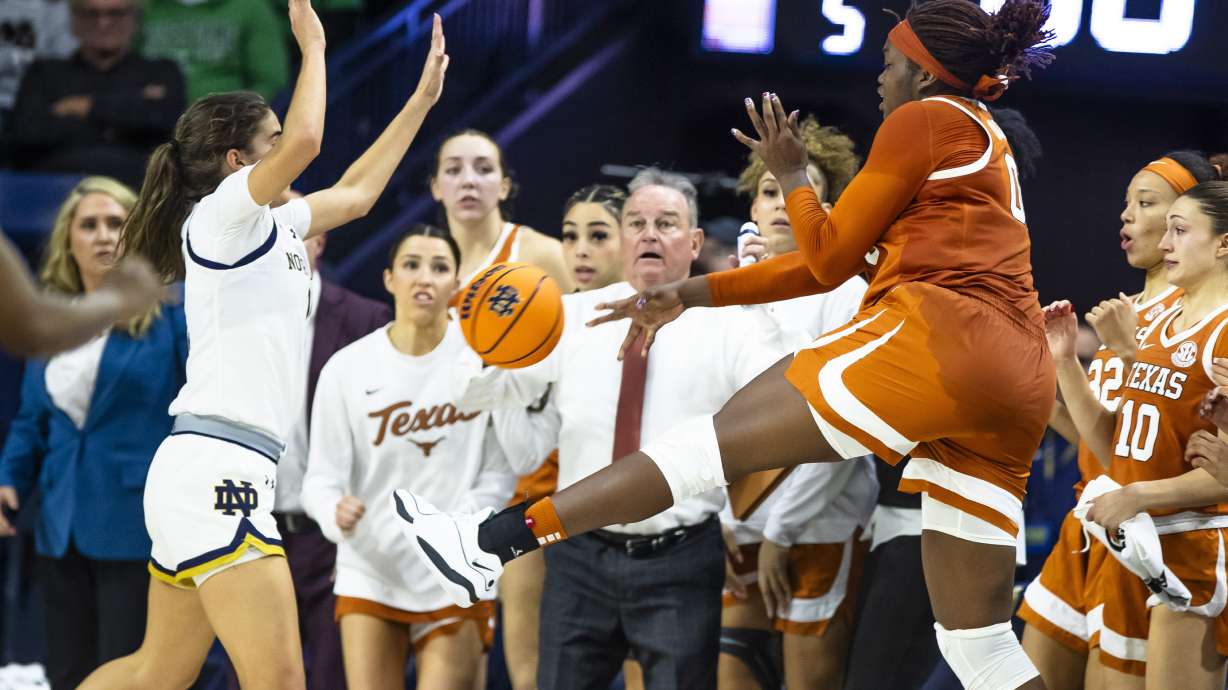 FILE - Texas forward Kyla Oldacre,front right, throws the ball toward Notre Dame guard Sonia Citron, front left, as she falls out of bounds during overtime of an NCAA college basketball game Thursday, Dec. 5, 2024, in South Bend, Ind.