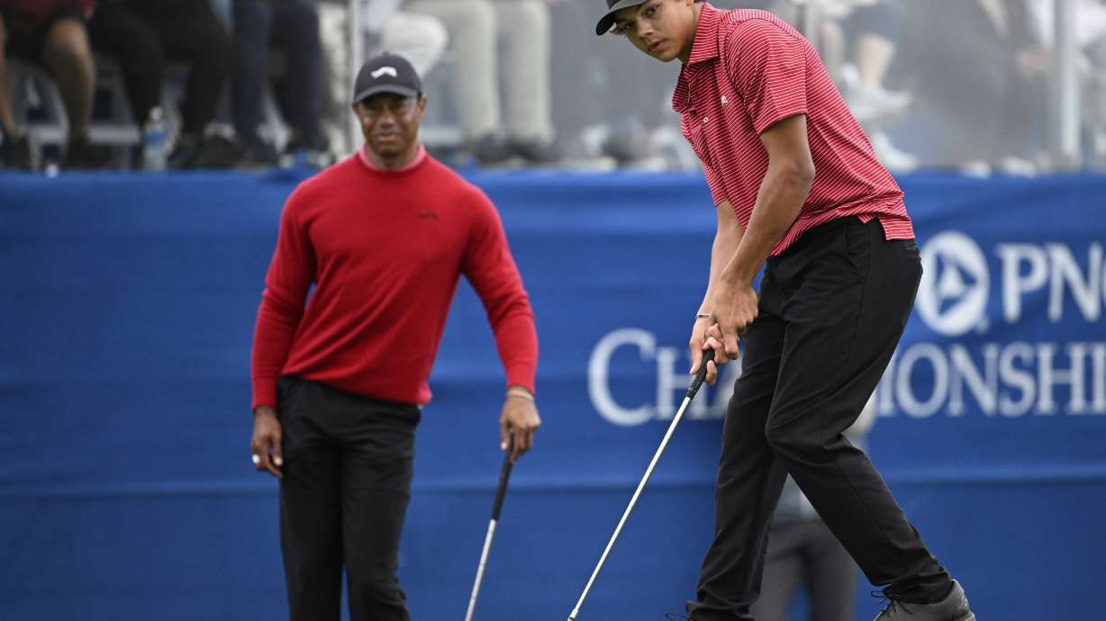 FILE - Tiger Woods watches his son, Charlie Woods, putt on the 18th green during the final round of the PNC Championship golf tournament, Sunday, Dec. 22, 2024, in Orlando, Fla.
