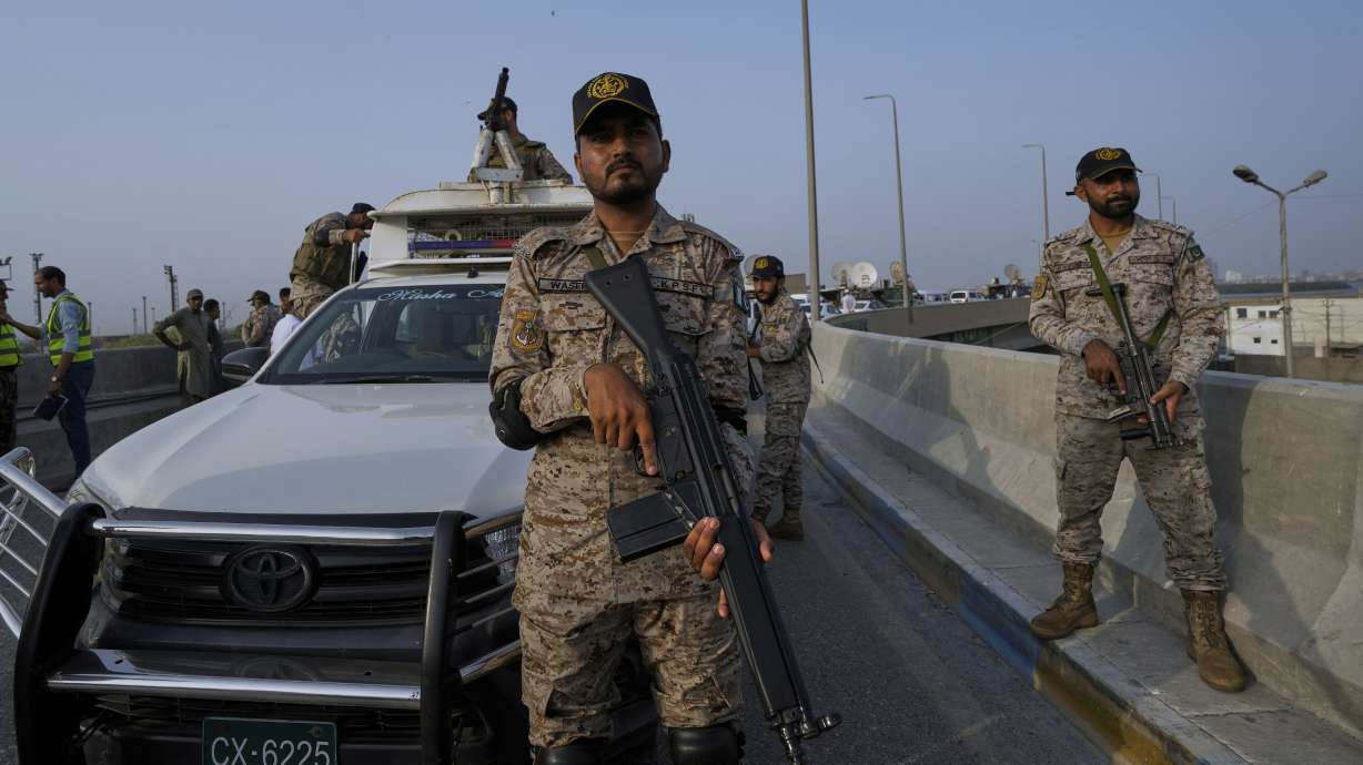 A paramilitary soldier stands alert on a road near Karachi port following rising military tension between Pakistan and India, in Karachi, Pakistan on Friday. Multiple explosions have been heard in two large cities of India-controlled Kashmir hours after India and Pakistan agreed to a ceasefire deal.