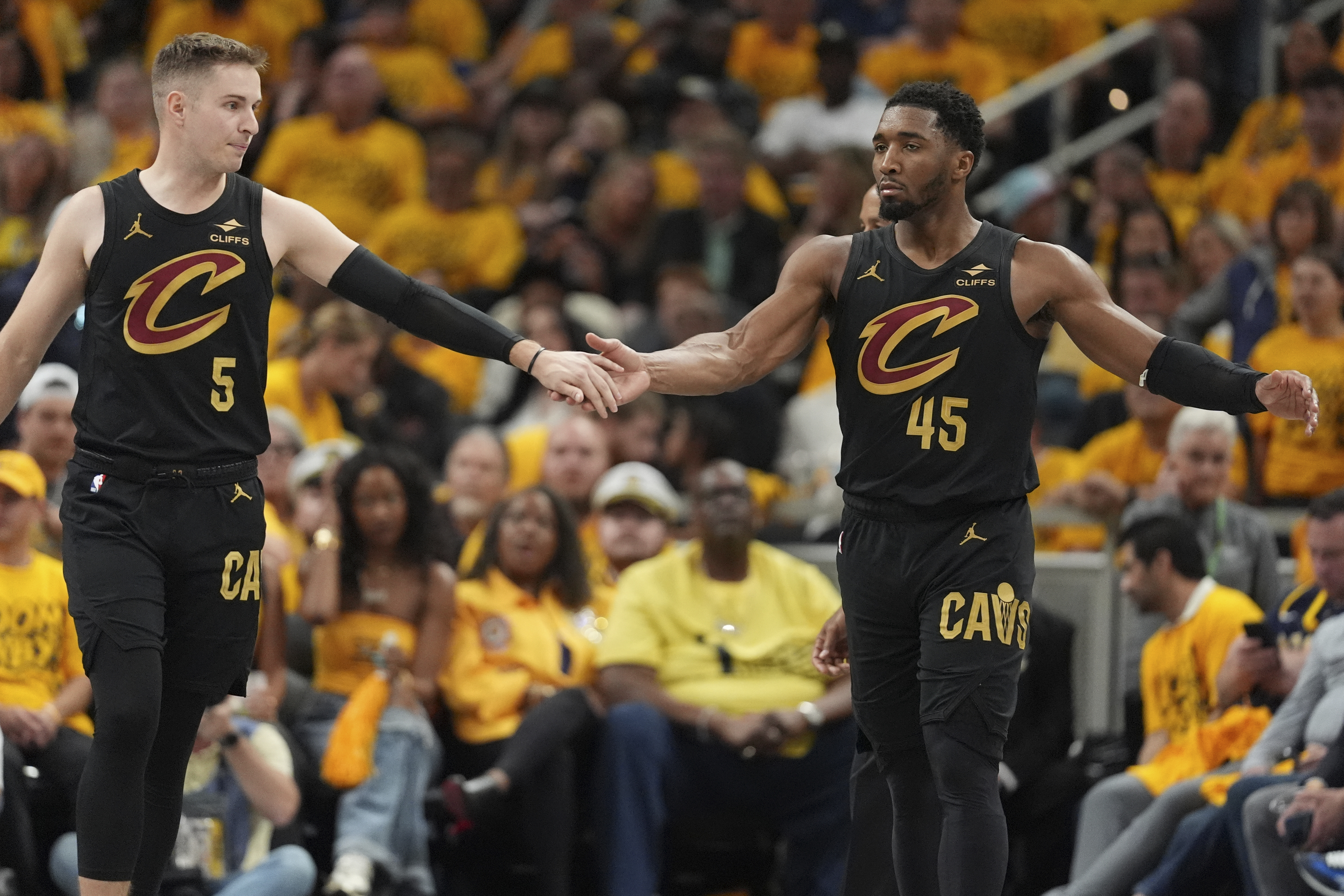 Cleveland Cavaliers guard Sam Merrill (5) and guard Donovan Mitchell (45) celebrate during the second half of Game 3 in the Eastern Conference semifinals of the NBA basketball playoffs against the Indiana Pacers in Indianapolis, Friday, May 9, 2025.