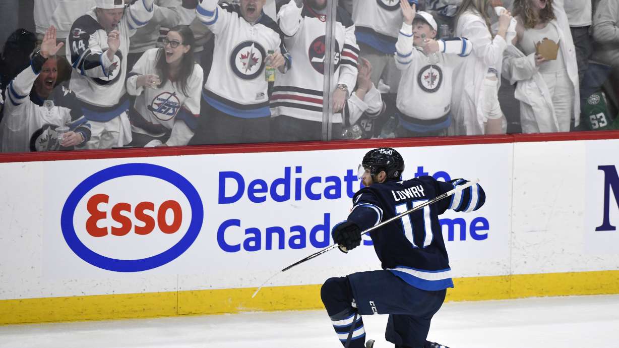 Winnipeg Jets' Adam Lowry (17) celebrates after his goal against the Dallas Stars during the second period of Game 2 of a second-round NHL hockey playoff series in Winnipeg, Manitoba, Friday, May 9, 2025.