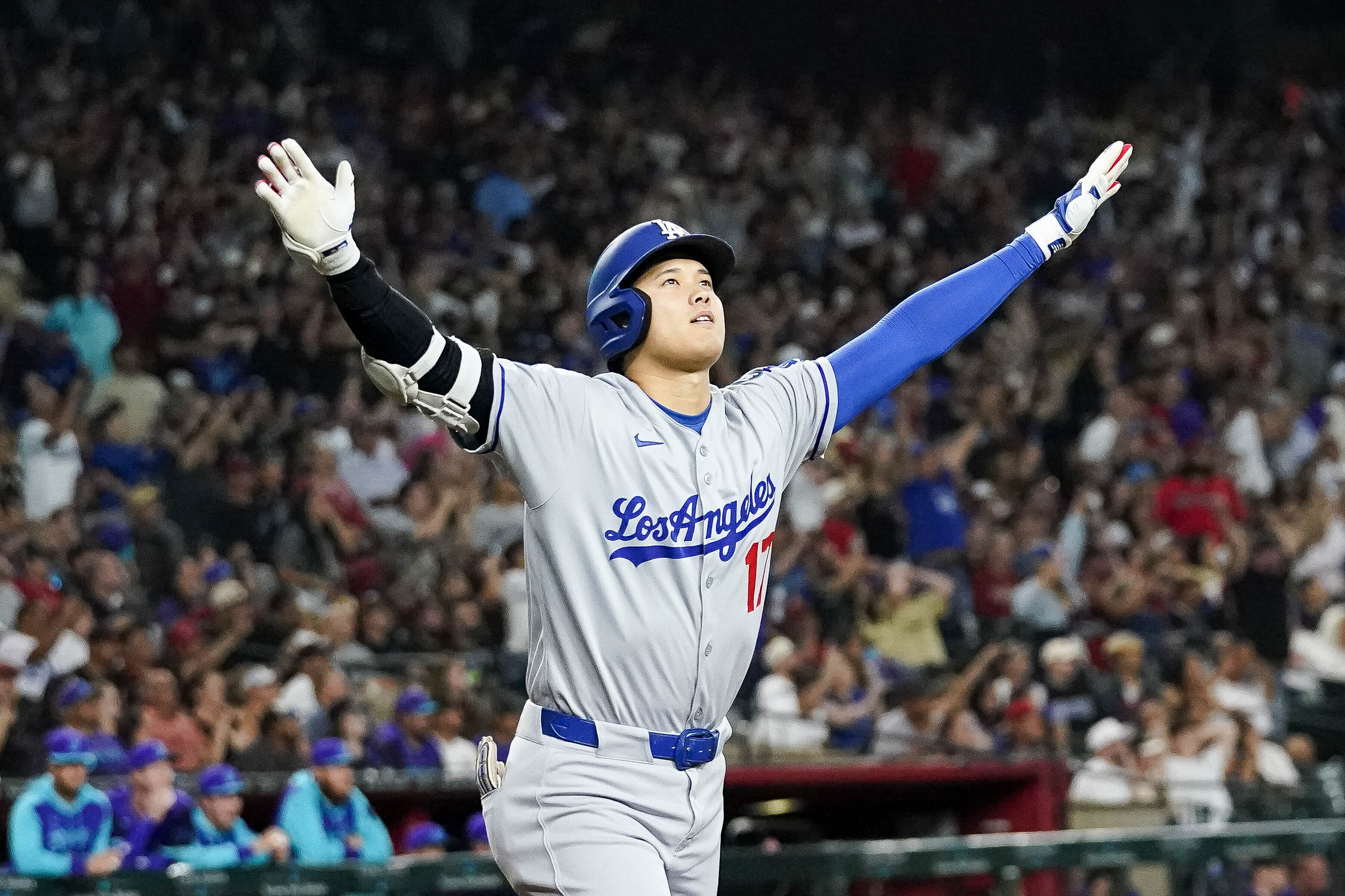 Los Angeles Dodgers' Shohei Ohtani celebrates a three run home run against for the Arizona Diamondbacks during the ninth inning of a baseball game Friday, May 9, 2025, in Phoenix.