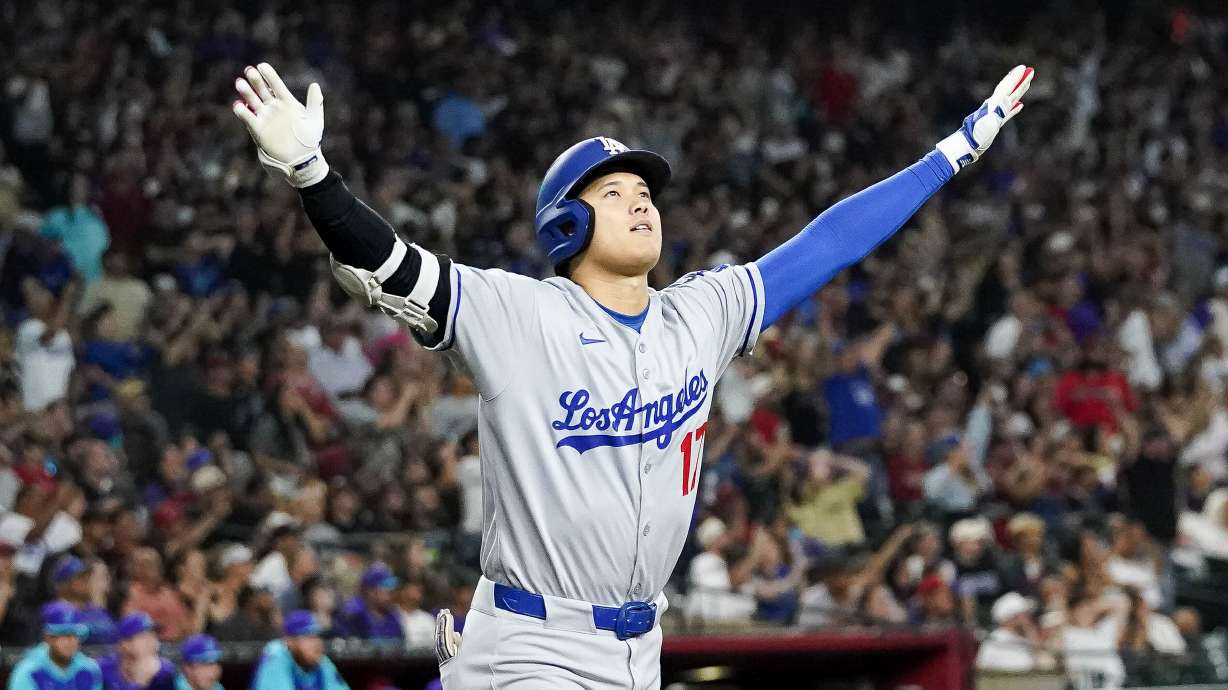 Los Angeles Dodgers' Shohei Ohtani celebrates a three run home run against for the Arizona Diamondbacks during the ninth inning of a baseball game Friday, May 9, 2025, in Phoenix.