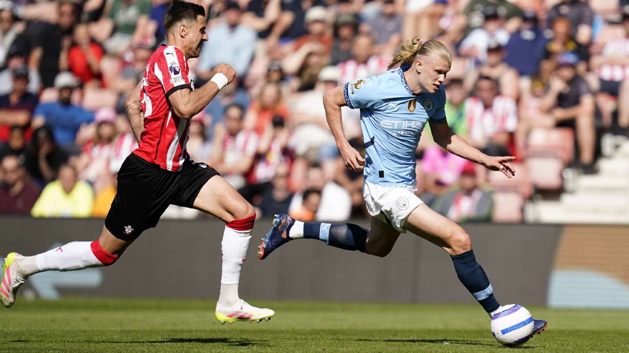 Manchester City's Erling Haaland, right, controls the ball from Southampton's Jan Bednarek during their Premier League soccer match at St Mary's Stadium, Southampton, England, Saturday May 10, 2025.
