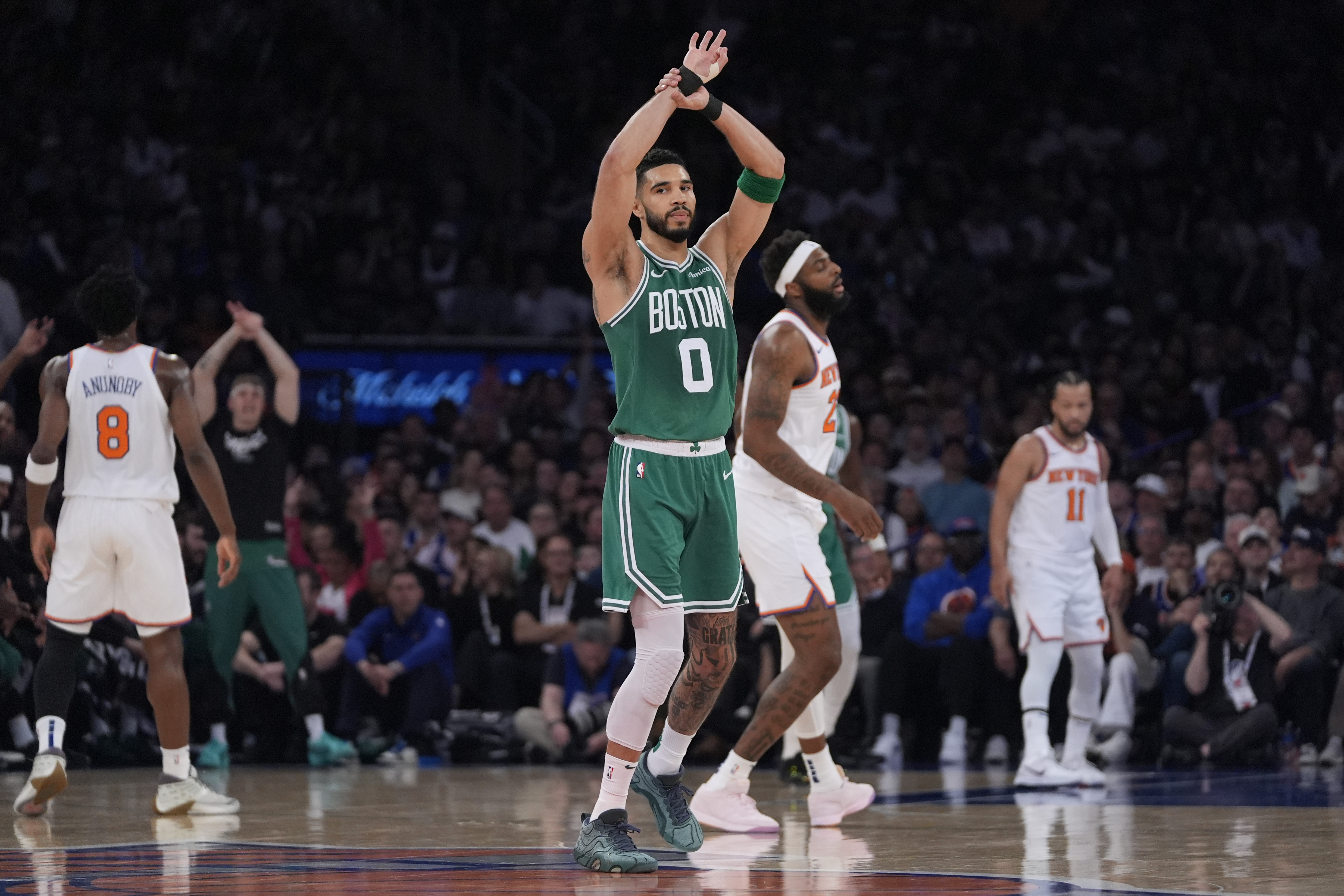 Boston Celtics' Jayson Tatum reacts after shooting a 3-point basket during the first half of Game 3 of an NBA basketball second-round playoff series against the New York Knicks, Saturday, May 10, 2025, in New York.