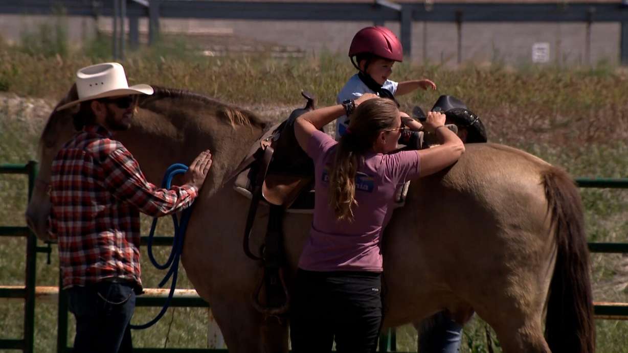 Amie Jarvie with her grandson T.J. Schweinler at Hoofbeats to Healing in Saratoga Springs on Saturday.