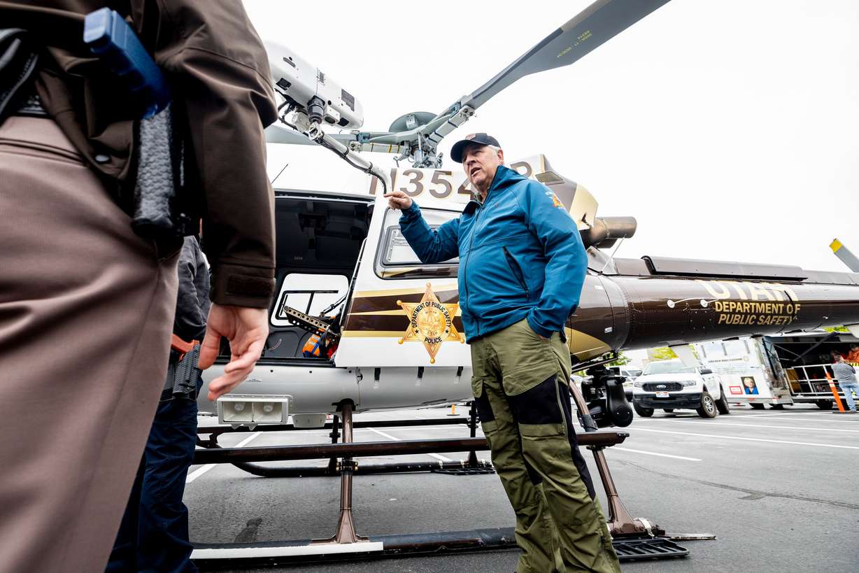 Utah Department of Public Safety pilot Kent Harrison talks with police officers during the first Find Yourself in Utah Law Enforcement Career Day held outside the Peace Officers Standards and Training Center on Salt Lake Community College’s Miller Campus in Sandy on April 30.