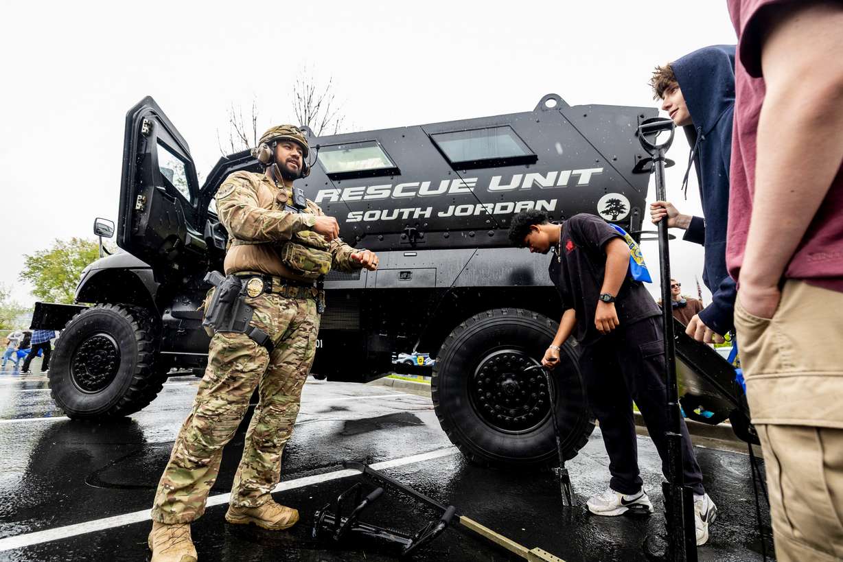 South Jordan police officer and SWAT team member Brentte Ugaitafa talks with students from various local high schools during the first Find Yourself in Utah Law Enforcement Career Day held outside the Peace Officers Standards and Training Center on Salt Lake Community College’s Miller Campus in Sandy on April 30.