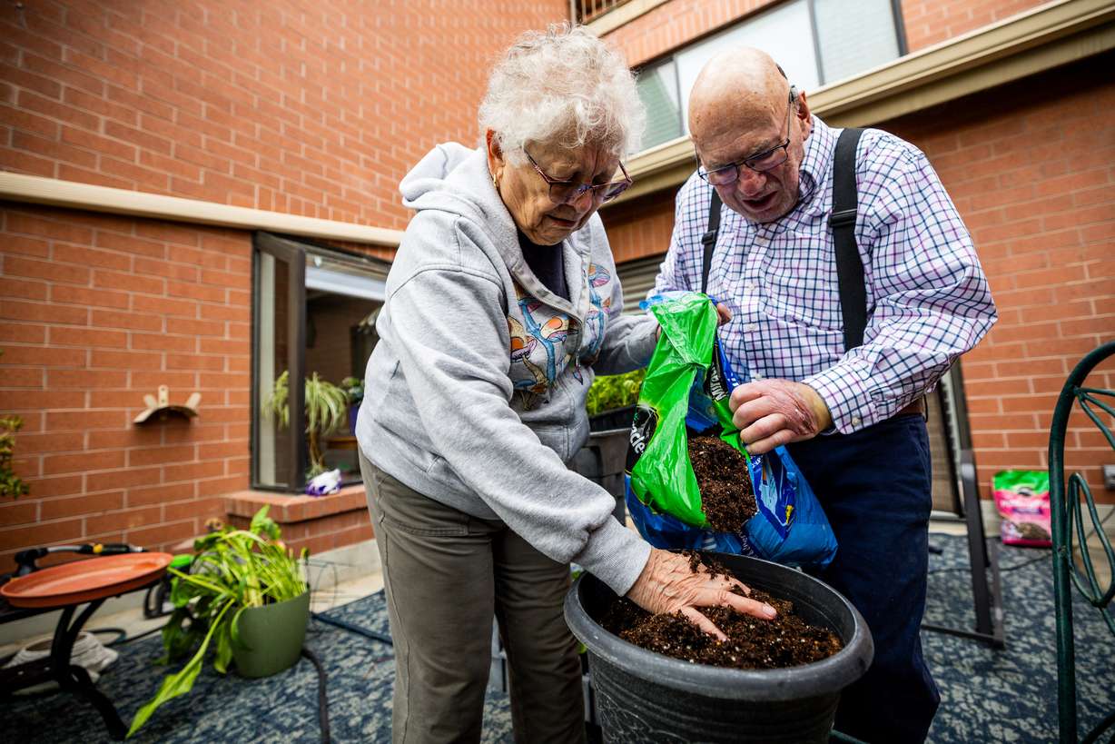 Sharl Karpf, 84, left, and husband Alan Karpf, 86, right, fill a container with soil at their home in Salt Lake City on May 5.