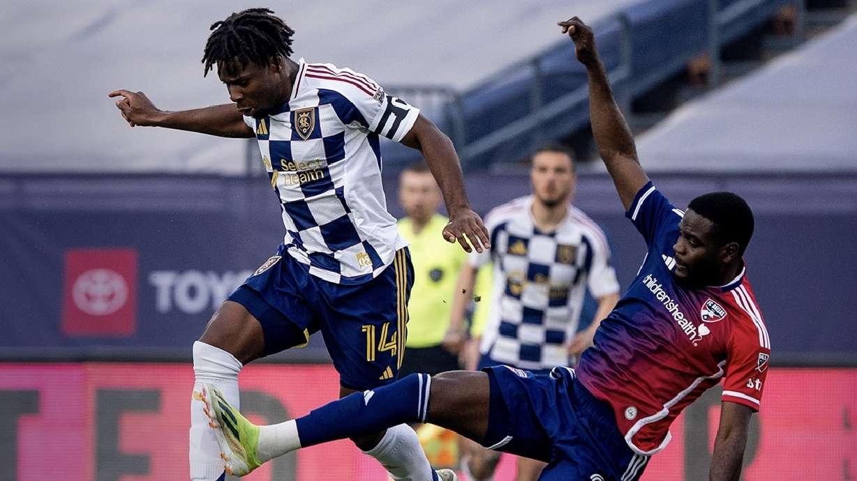 Emeka Eneli, left, escapes a Dallas defender.