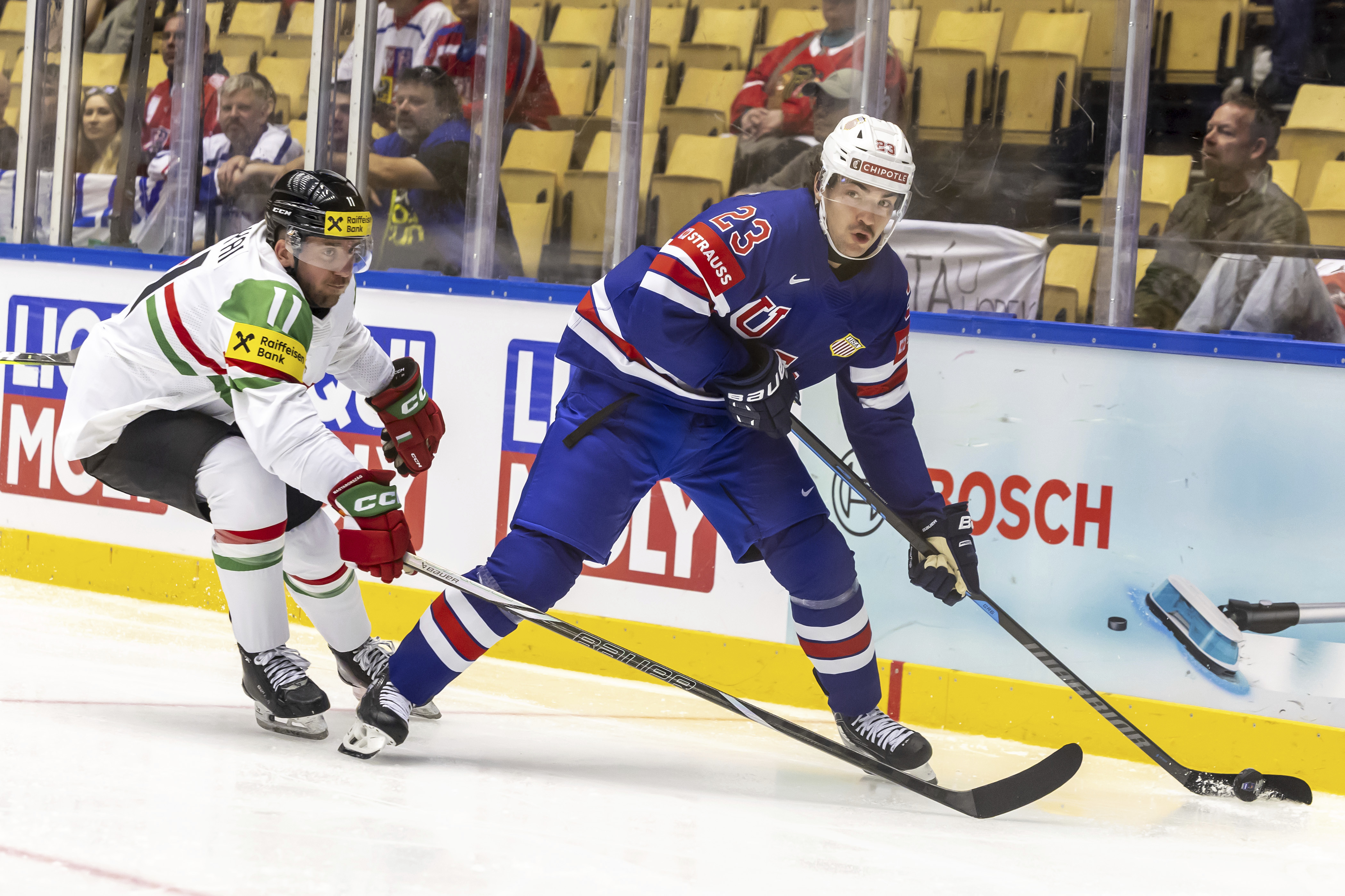 Hungary's defender Gabor Tornyai, left, vies for the puck with USA's forward Mikey Eyssimont, during the IIHF 2025 World Championship preliminary round group B game between USA and Hungary, at the Jyske Bank Boxen, in Herning, Denmark, Sunday, May 11, 2025.