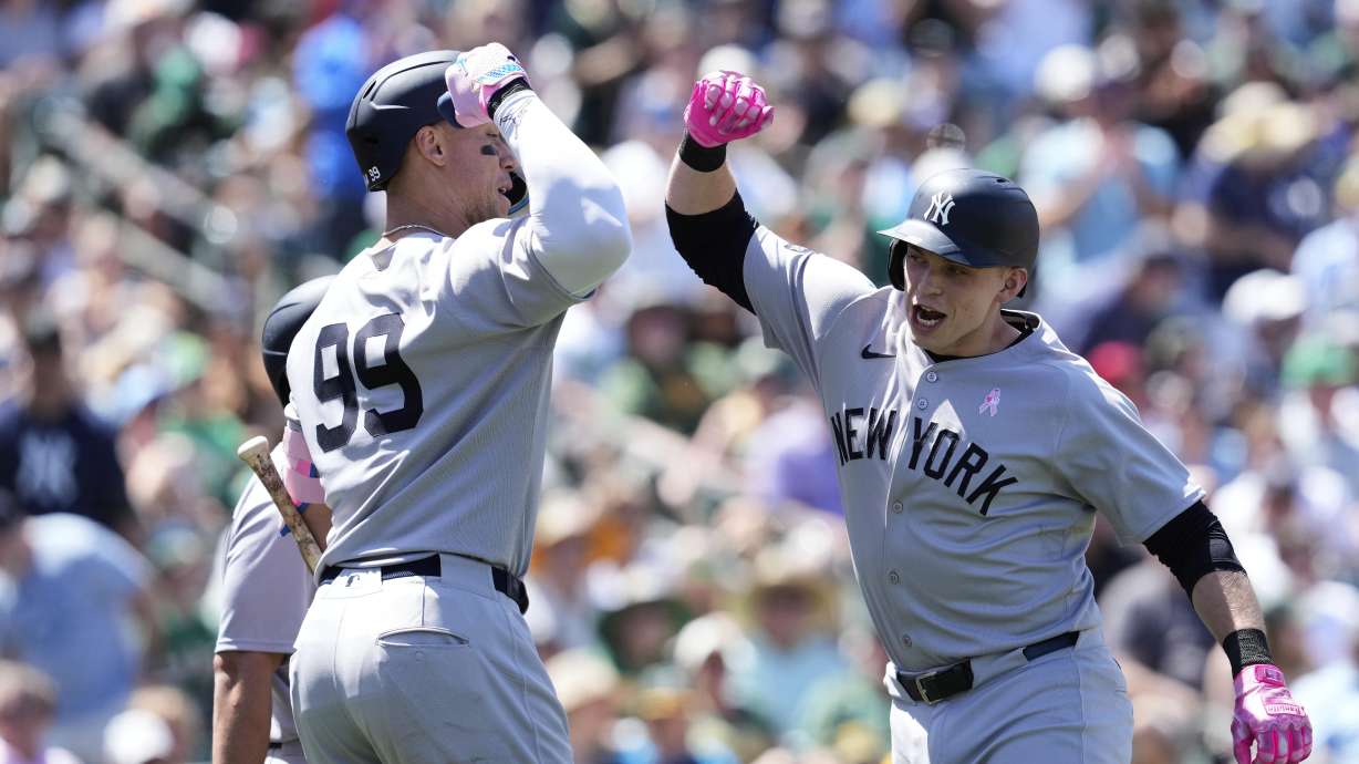 New York Yankees' Ben Rice, right, celebrates with Aaron Judge after hitting a grand slam during the fifth inning of a baseball game against the Athletics, Sunday, May 11, 2025, in West Sacramento, Calif.