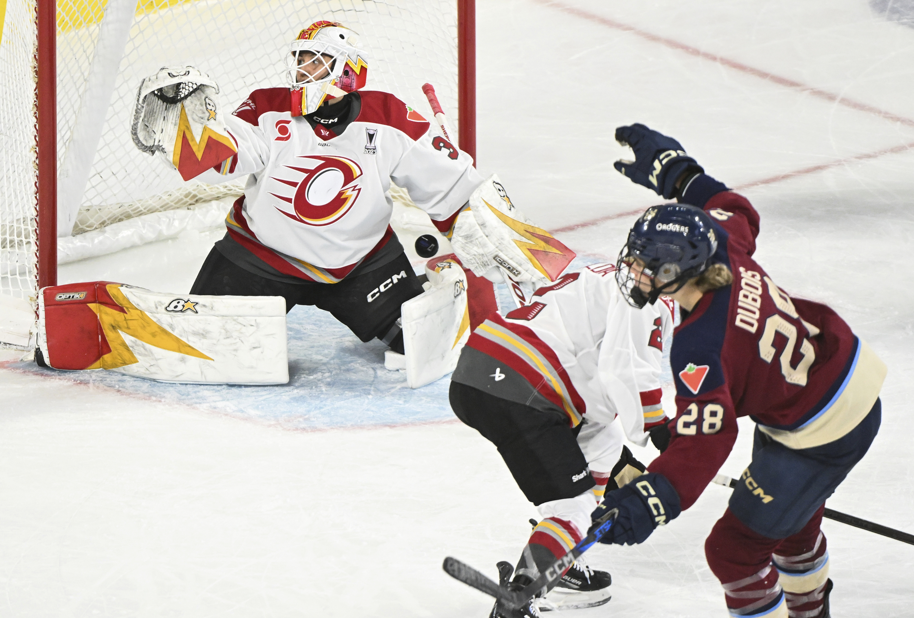 Montreal Victoire's Catherine Dubois (28) scores against Ottawa Charge goaltender Gwyneth Philips, left, during fourth overtime period PWHL playoff hockey action in Laval, Quebec, Sunday, May 11, 2025.