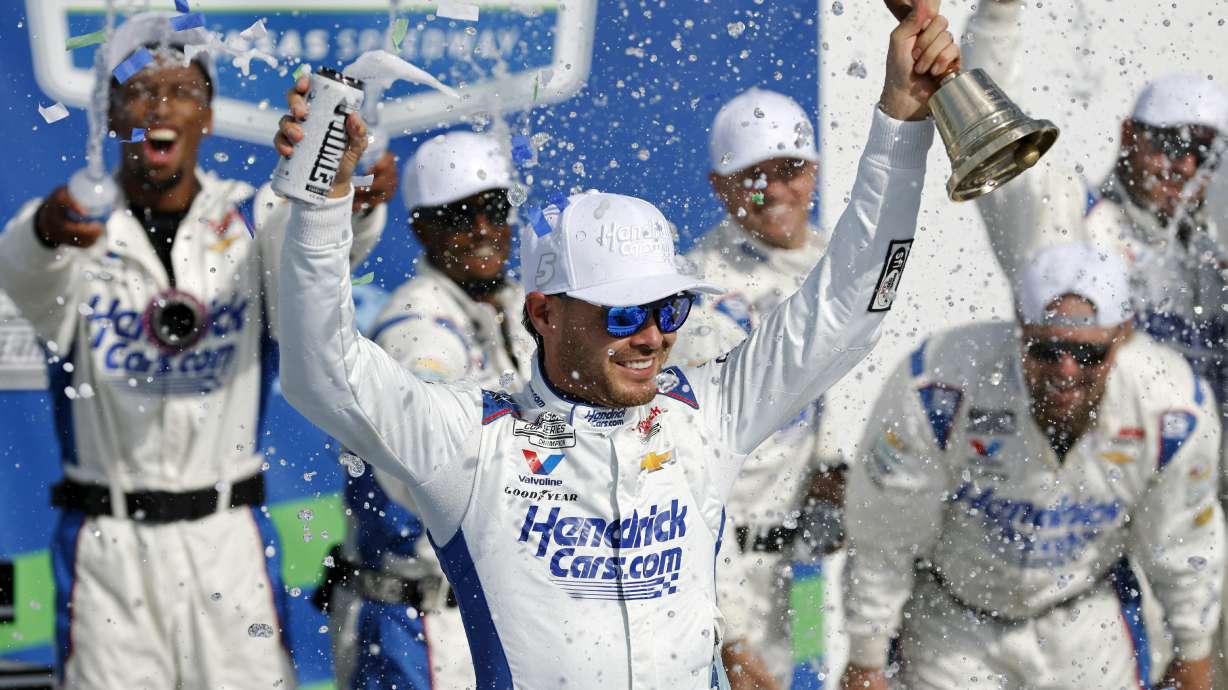 Kyle Larson, center, celebrates in Victory Lane after winning a NASCAR Cup Series auto race at Kansas Speedway in Kansas City, Kan., Sunday, May 11, 2025.