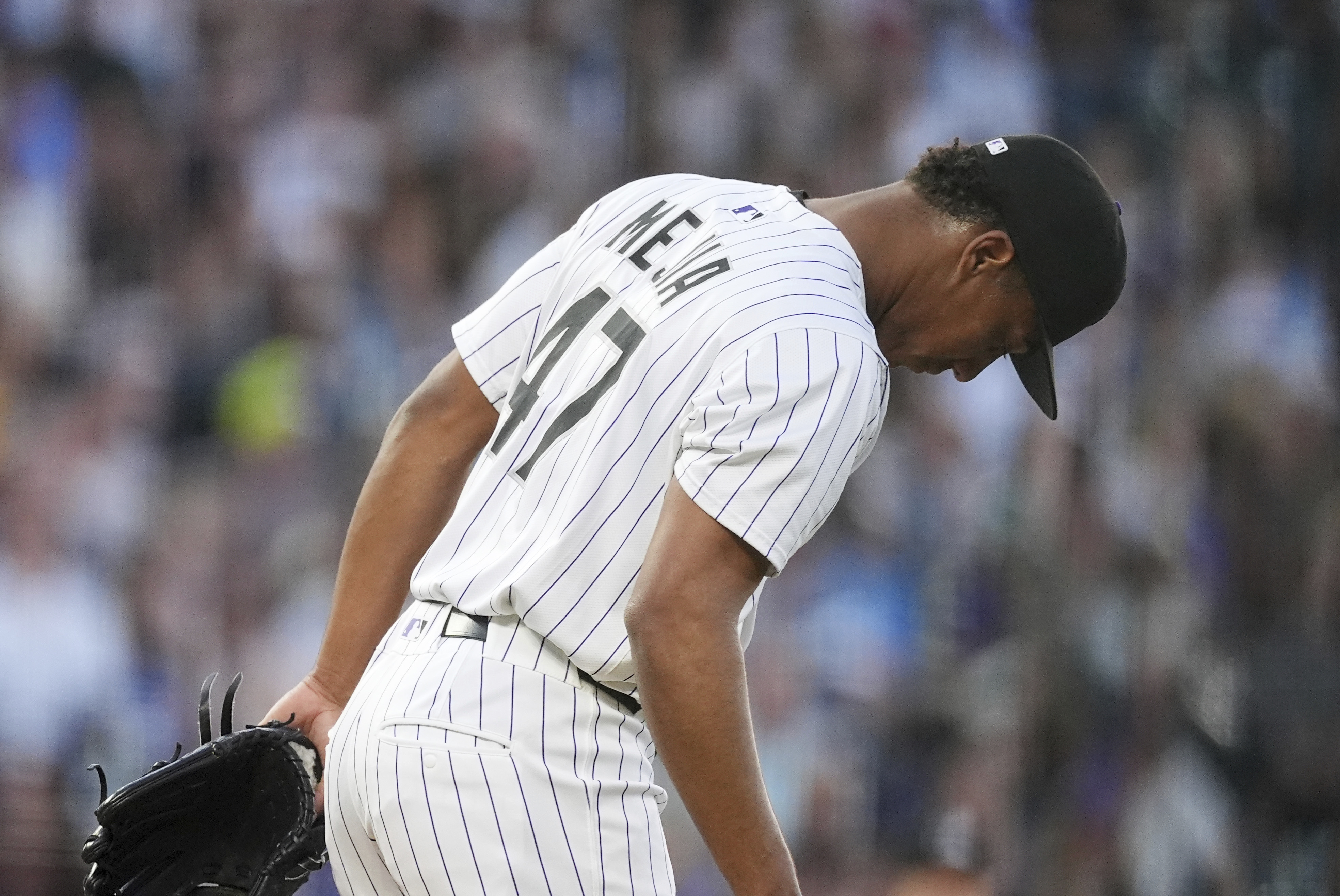 Colorado Rockies relief pitcher Juan Mejia reacts after giving up a three-run home run to San Diego Padres' Fernando Tatis Jr. in the fifth inning of a baseball game Saturday, May 10, 2025, in Denver.